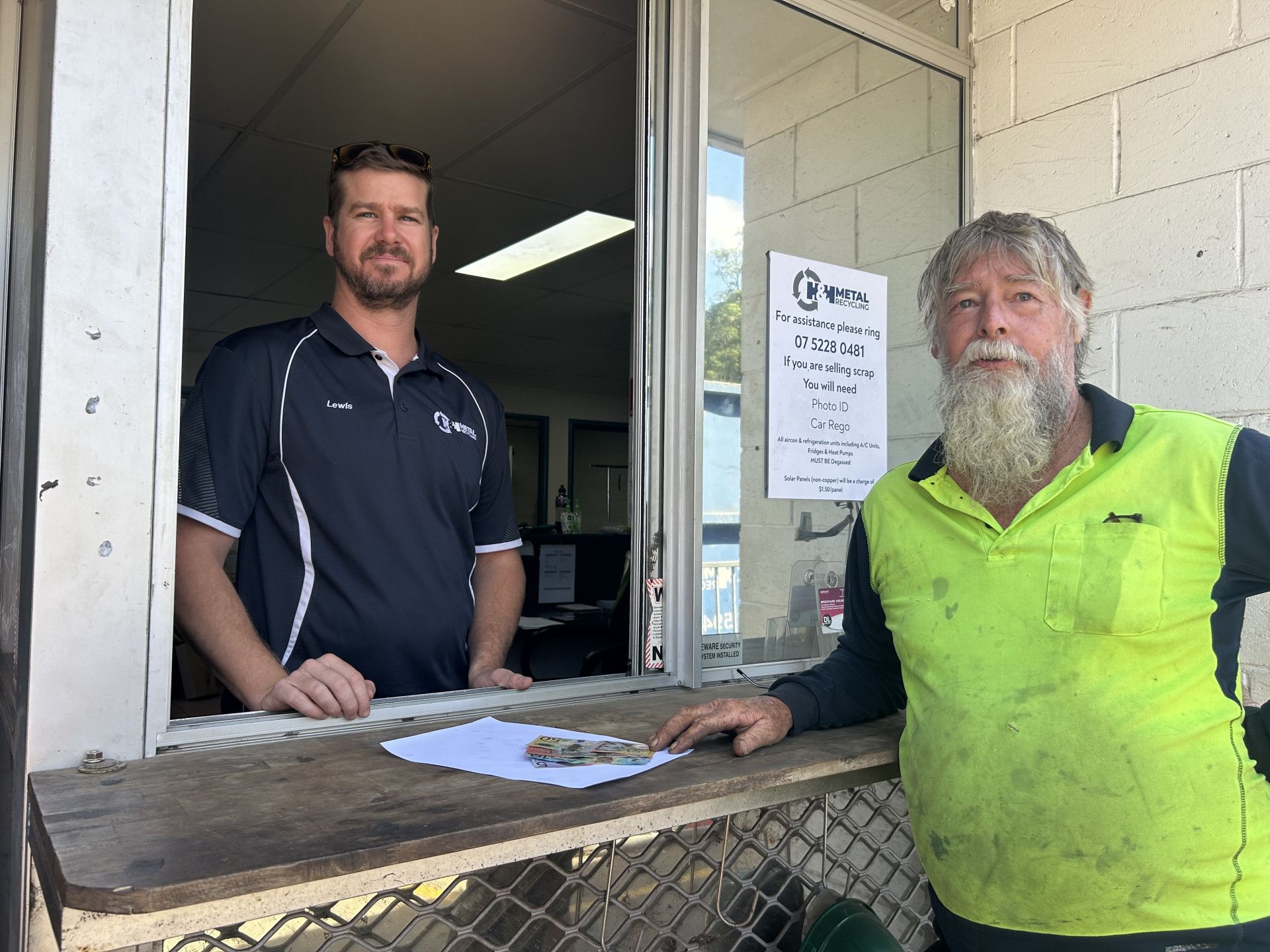 A Man Wearing Sunglasses Is Holding a Stack of Money — H & H Metal Recycling In Coolum, QLD