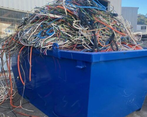 A Blue Dumpster Filled with A Pile of Wires — H & H Metal Recycling In Kawana Waters, QLD