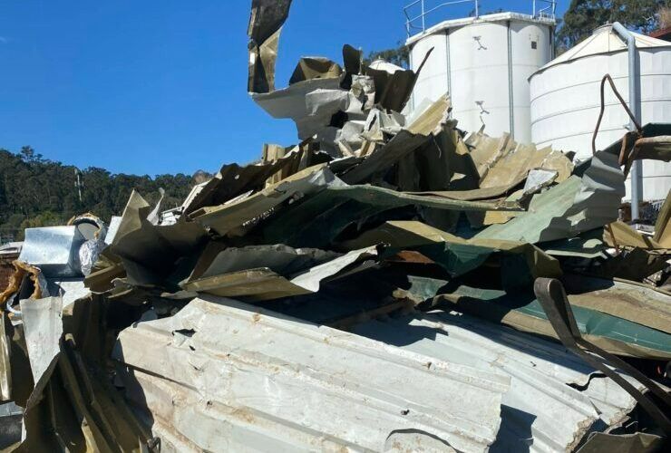 A Pile of Scrap Metal Is Sitting in Front of A Building — H & H Metal Recycling In Coolum, QLD