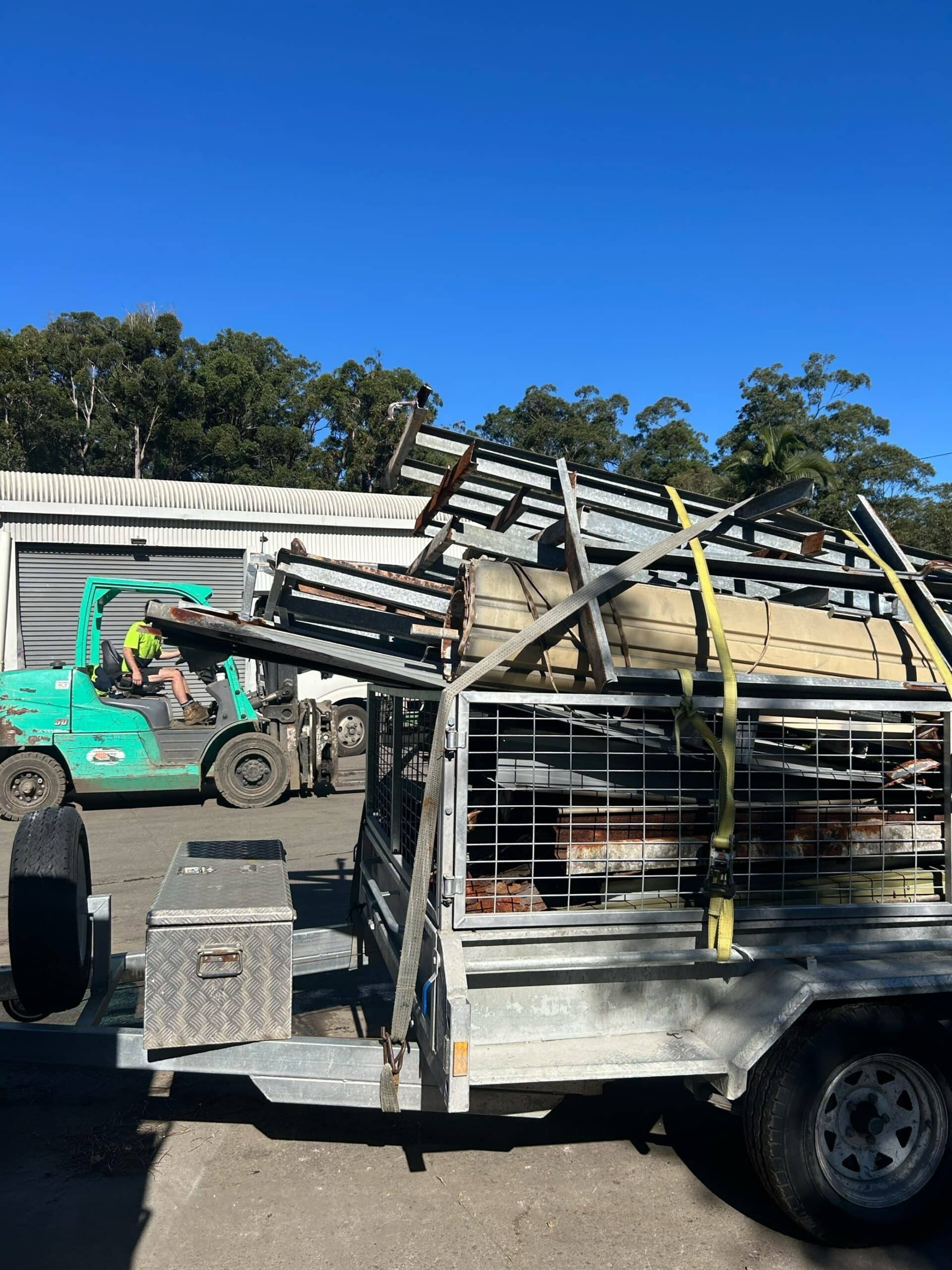 A Forklift Is Loading a Trailer with A Bunch of Boxes on It — H & H Metal Recycling In Noosa, QLD