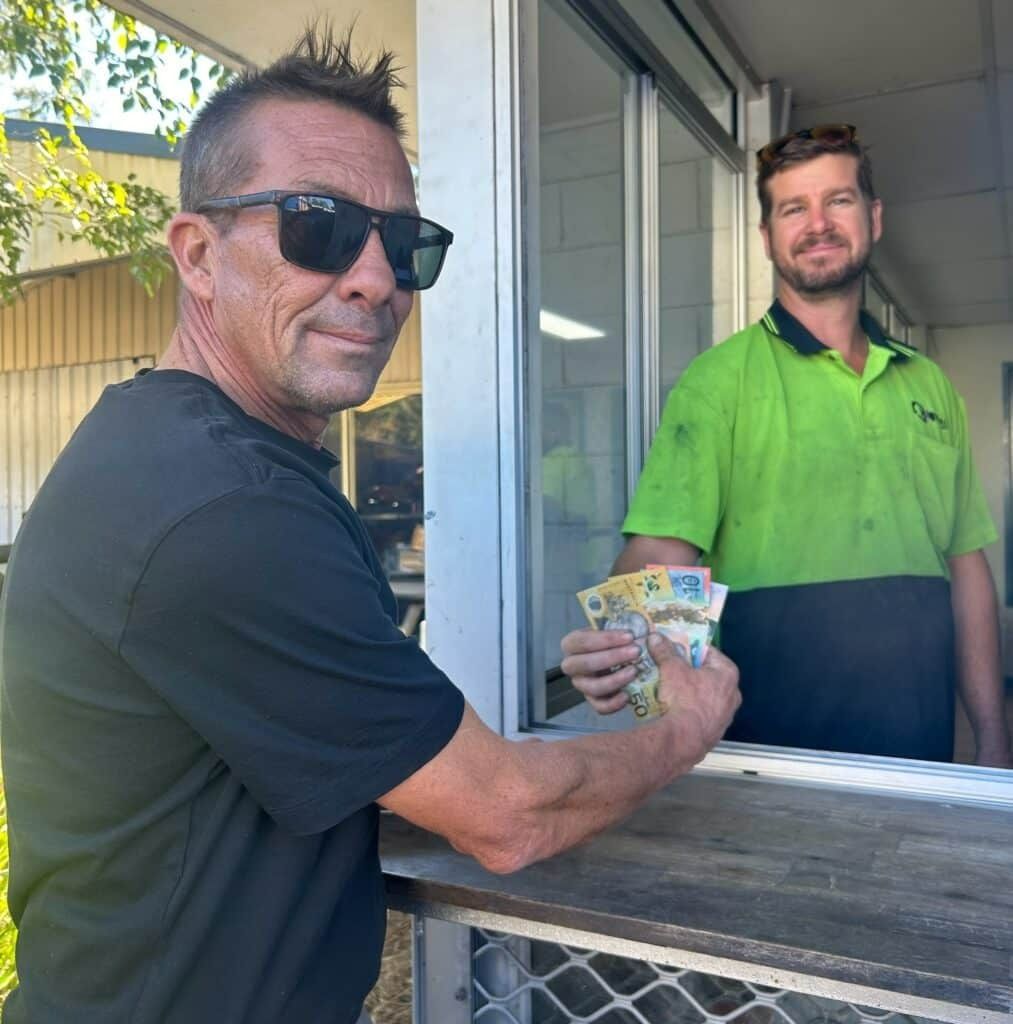 A Man Wearing Sunglasses Is Holding a Stack of Money — H & H Metal Recycling In Coolum, QLD