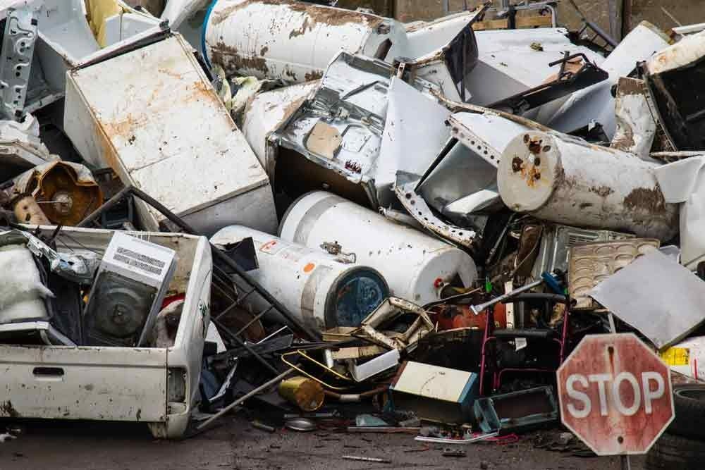 A Pile of Junk with A Stop Sign in The Foreground — H & H Metal Recycling In Nambour, QLD