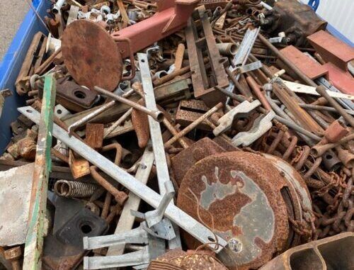 A Pile of Rusty Metal Is Sitting in A Blue Bin — H & H Metal Recycling In Kunda Park, QLD