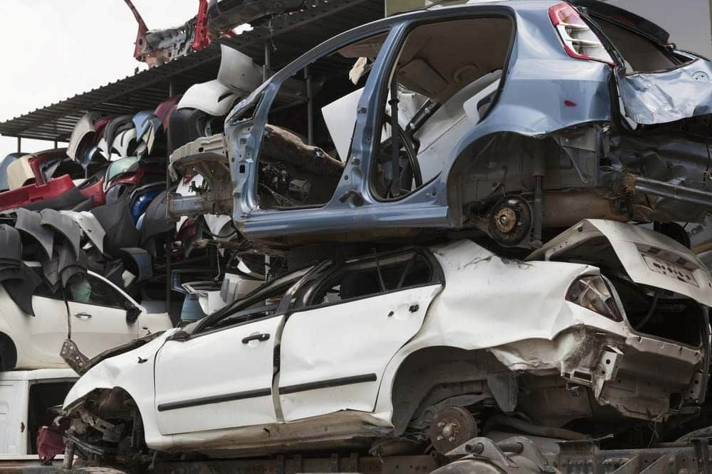 A Pile of Wrecked Cars Are Stacked on Top of Each Other — H & H Metal Recycling In Kunda Park, QLD