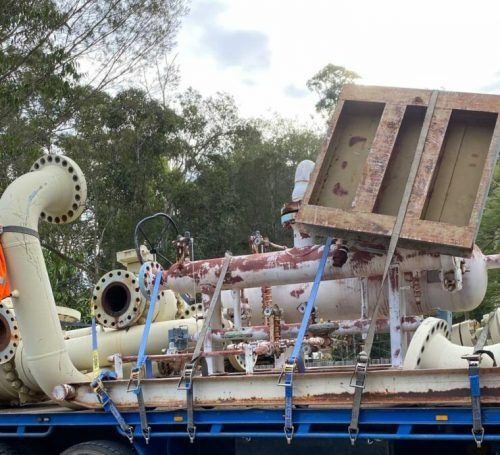 A Blue Truck with A Bunch of Pipes on It — H & H Metal Recycling In Noosa, QLD