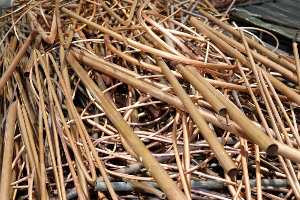 A Pile of Copper Pipes Sitting on Top of Each Other — H & H Metal Recycling In Kunda Park, QLD