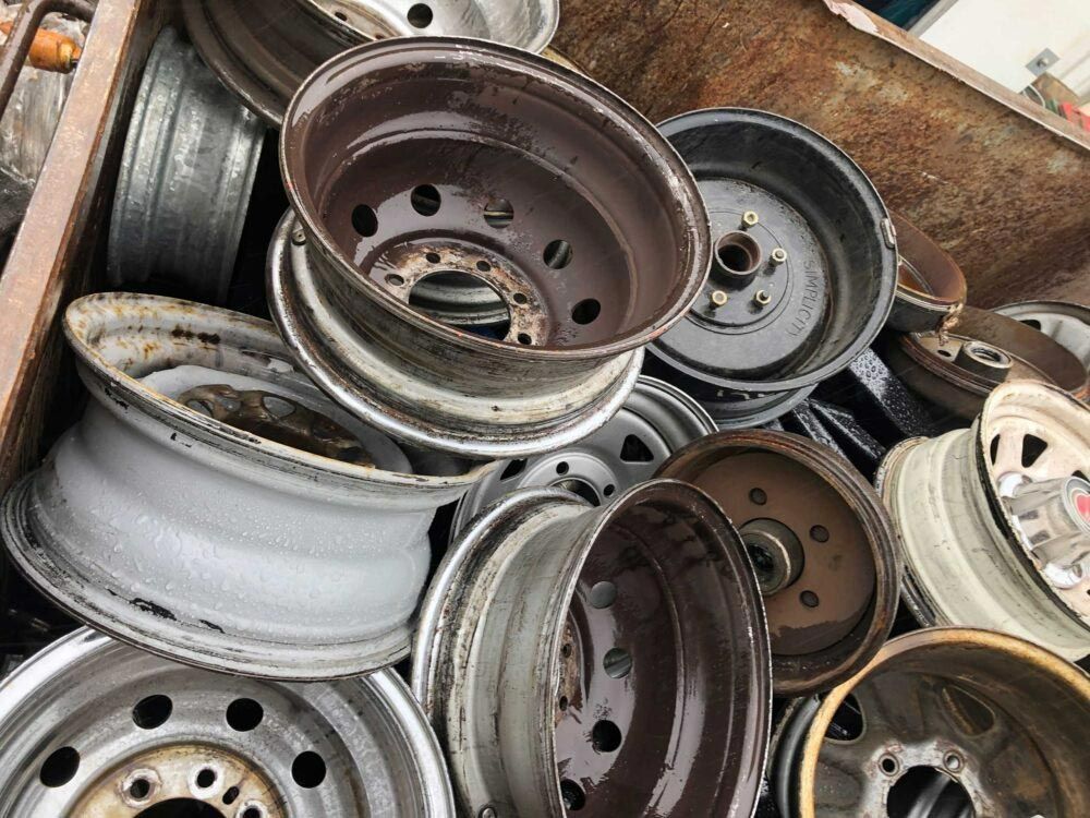 A Pile of Wheels Are Stacked on Top of Each Other — H & H Metal Recycling In Maroochydore, QLD