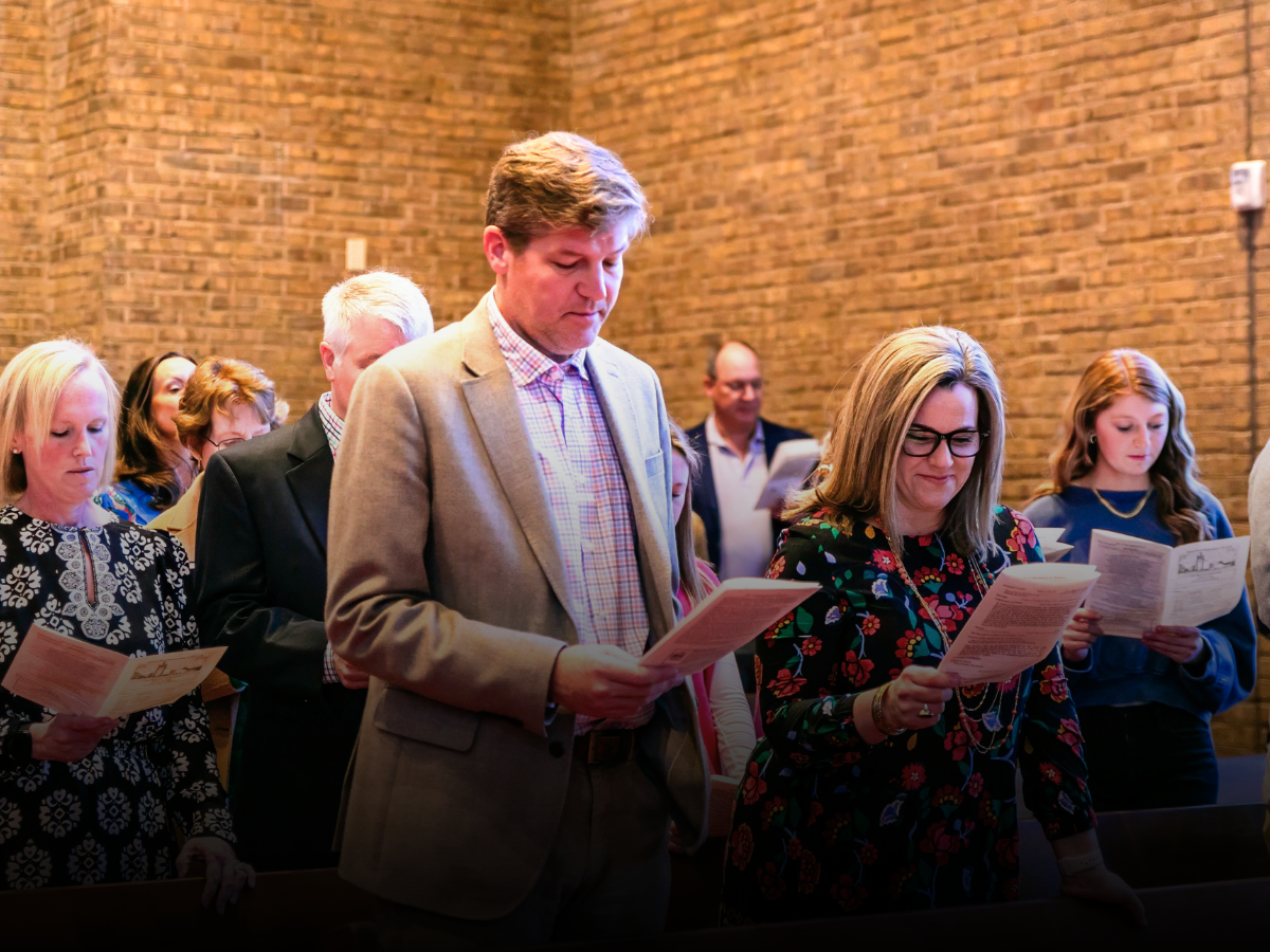 A group of people are singing in a church.