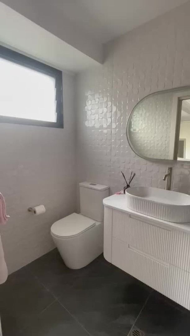 Bathroom with white textured tile walls, dark floor, and modern sink vanity — Cobra Plumbing & Bathrooms in Heathcote, NSW