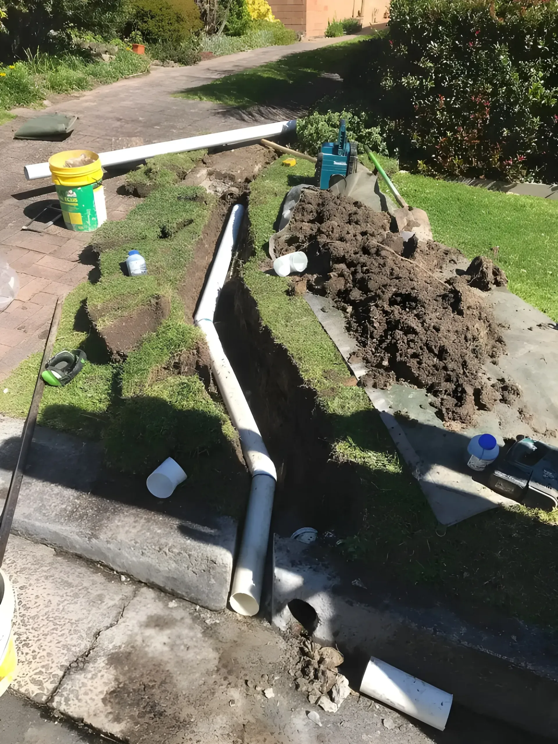 Trench Dug on a Lawn With Pvc Pipes for Drainage — Cobra Plumbing & Bathrooms in Heathcote, NSW