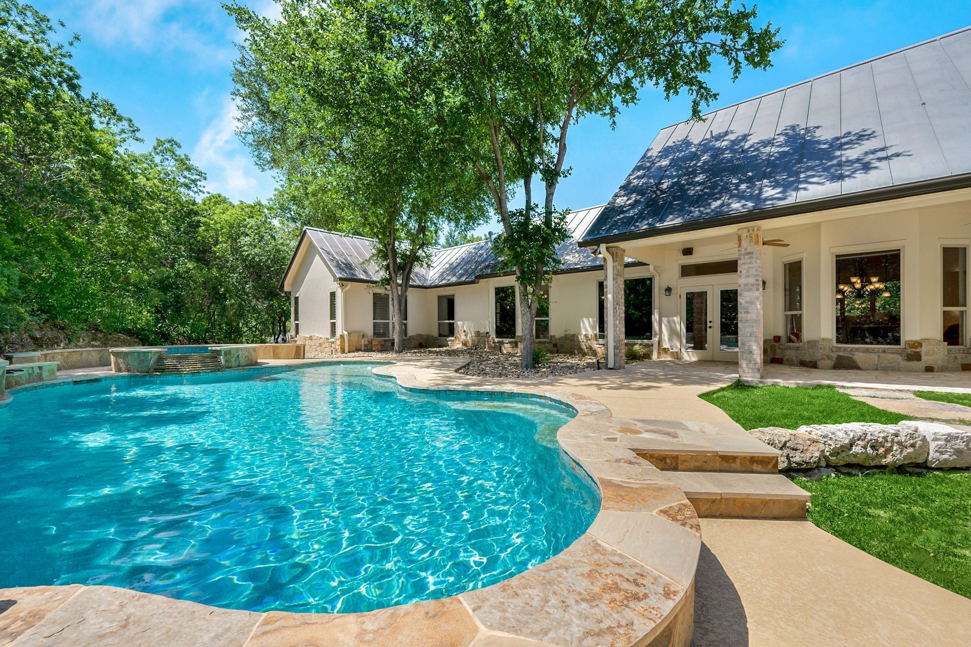 A large house with a large swimming pool in front of it