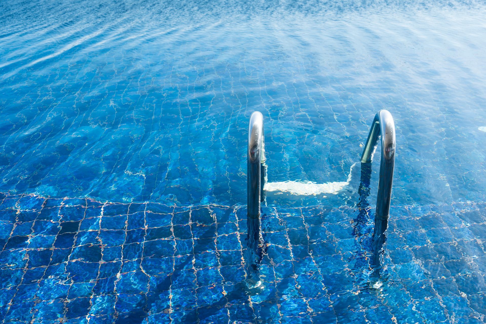 A swimming pool with stairs leading into the water.