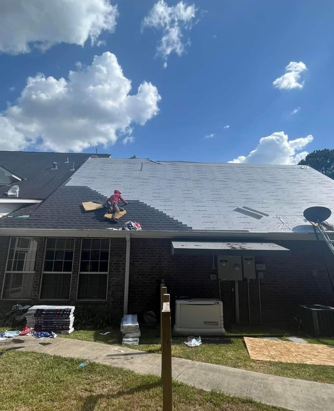 A man is working on the roof of a house.