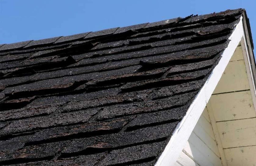 A close up of a roof with a blue sky in the background.