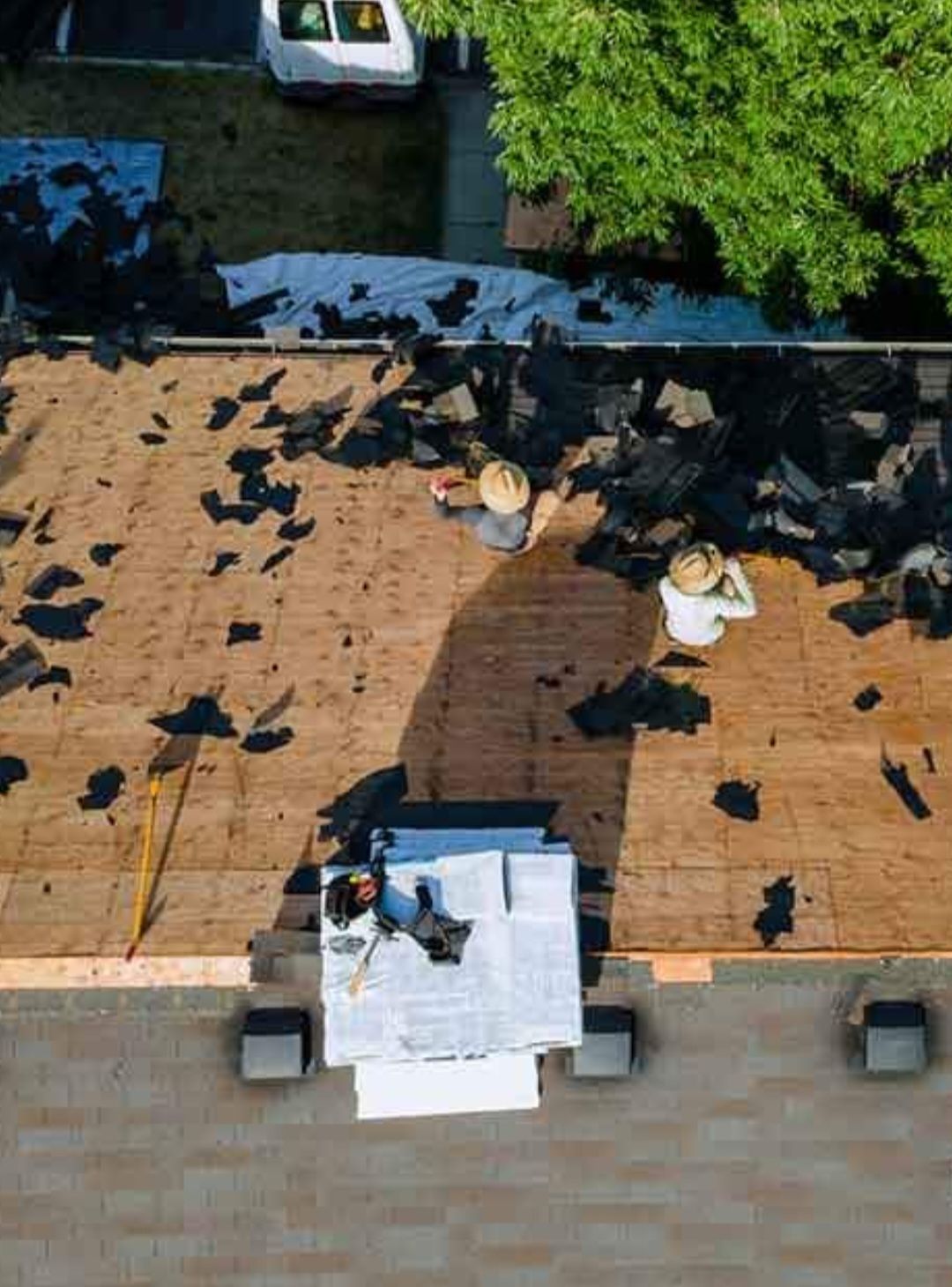 A group of people are working on a roof.