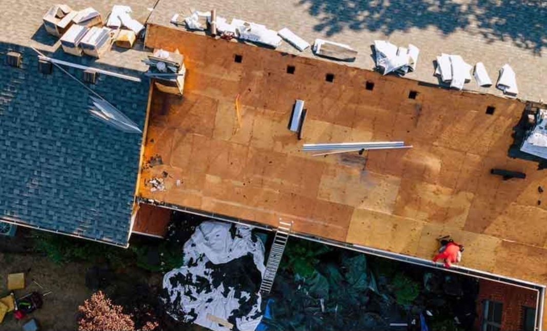 An aerial view of a roof being installed on a house.