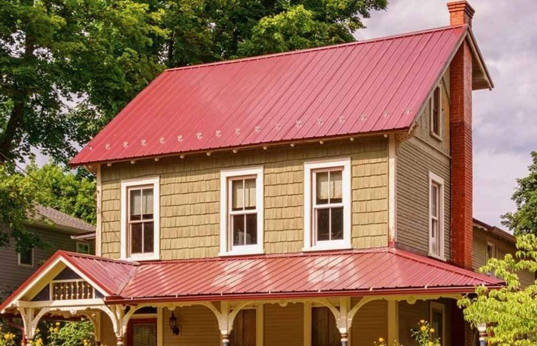 A house with a red roof and a porch