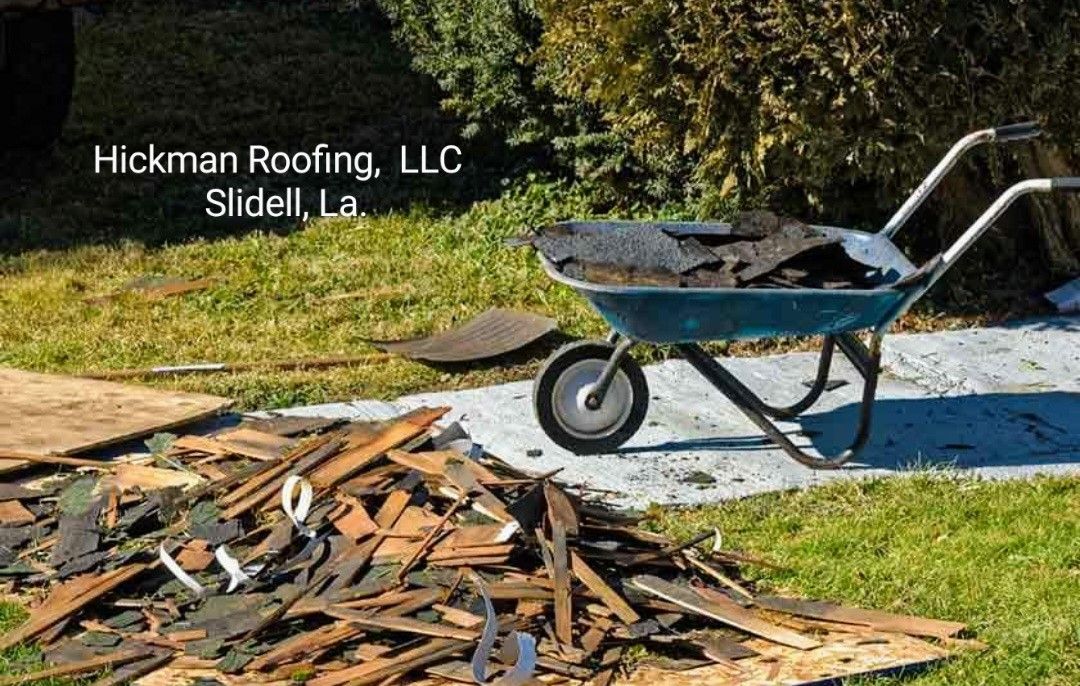 A wheelbarrow filled with shingles is sitting on top of a pile of shingles.