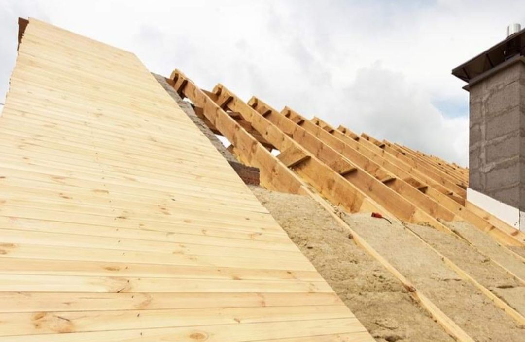 A wooden roof is being built on top of a building.