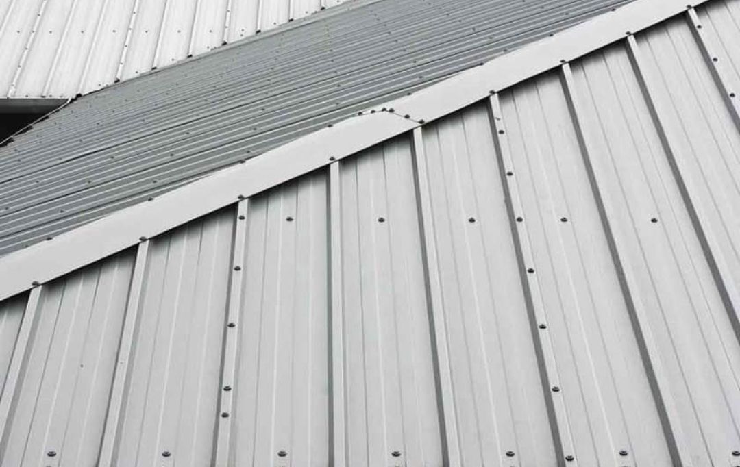 A close up of a white metal roof on a building.