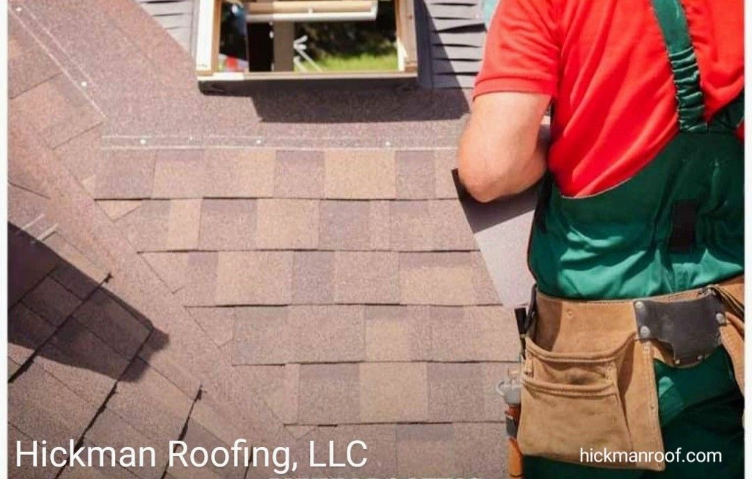 A man is laying shingles on a roof.