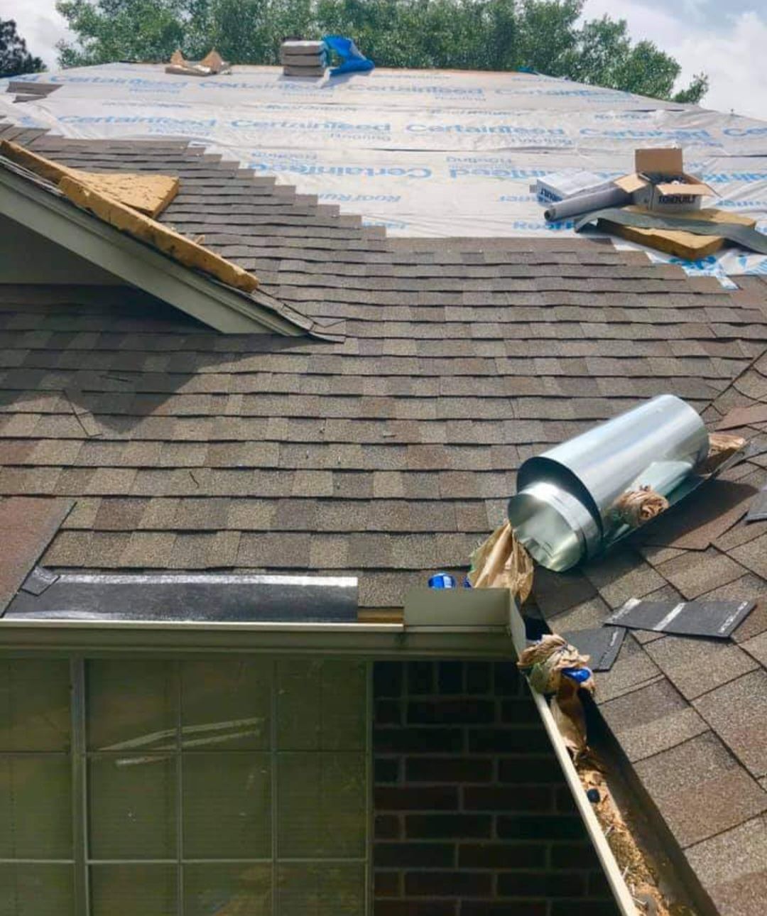 A roof with shingles being installed on it