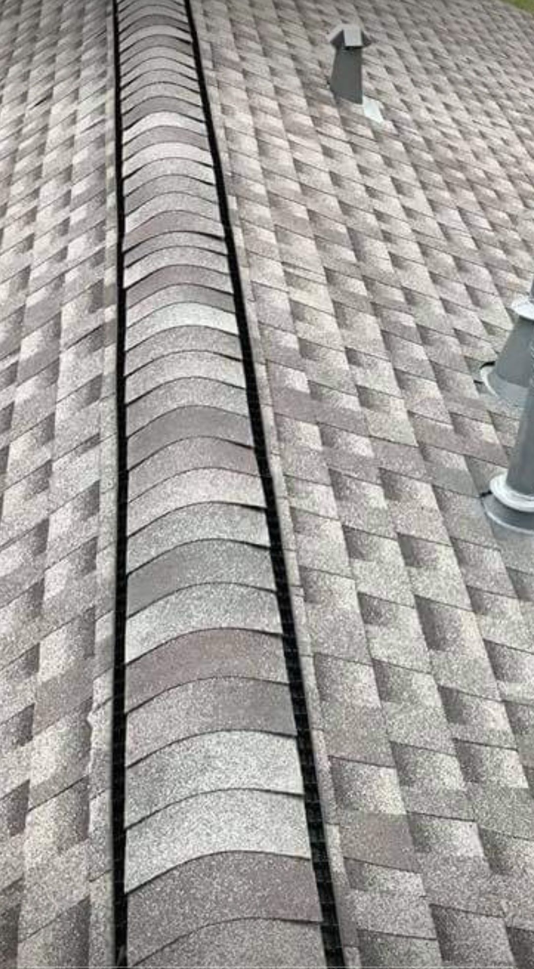 A close up of a roof with a drain on it.