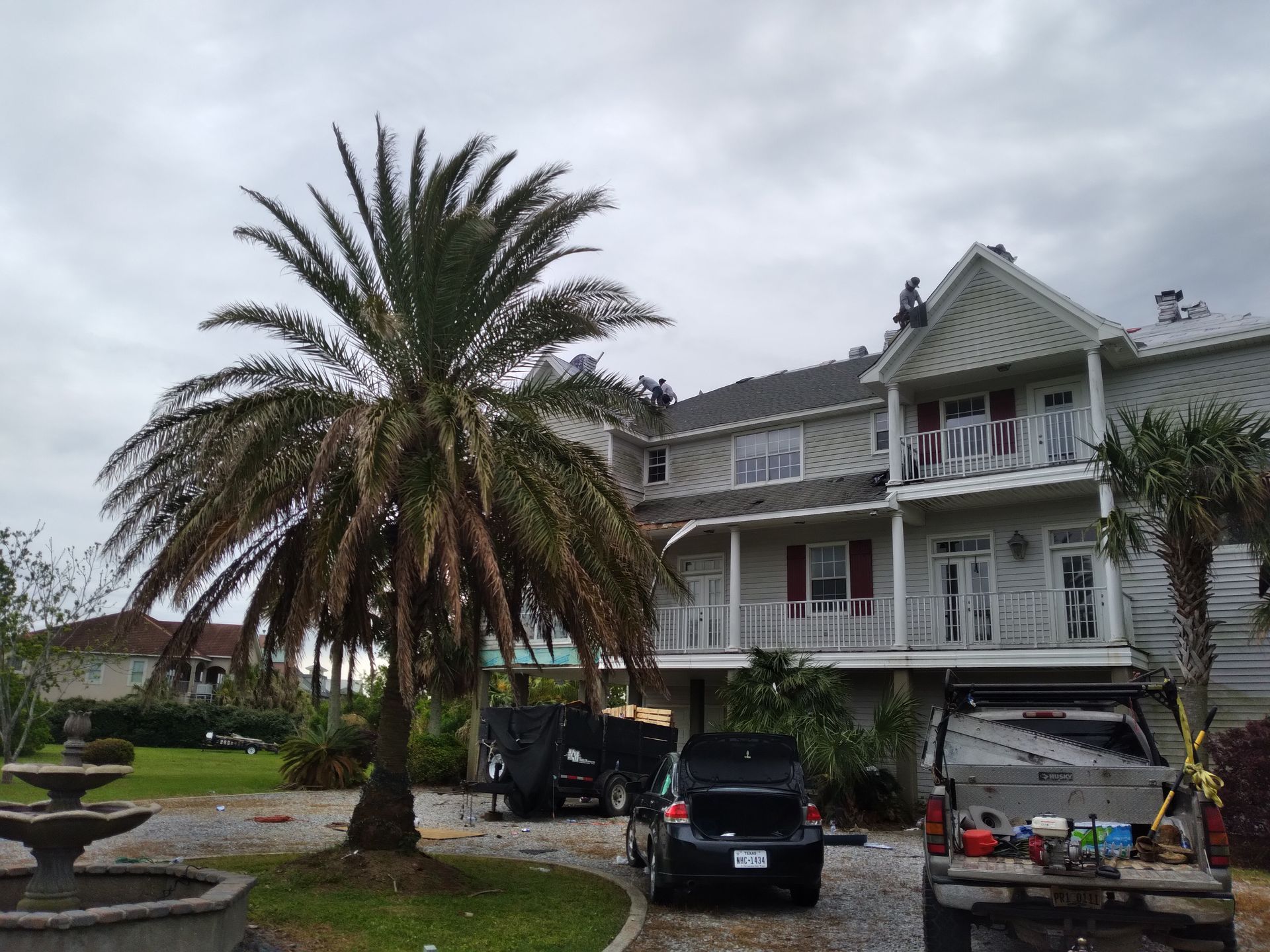 A large house with a palm tree in front of it