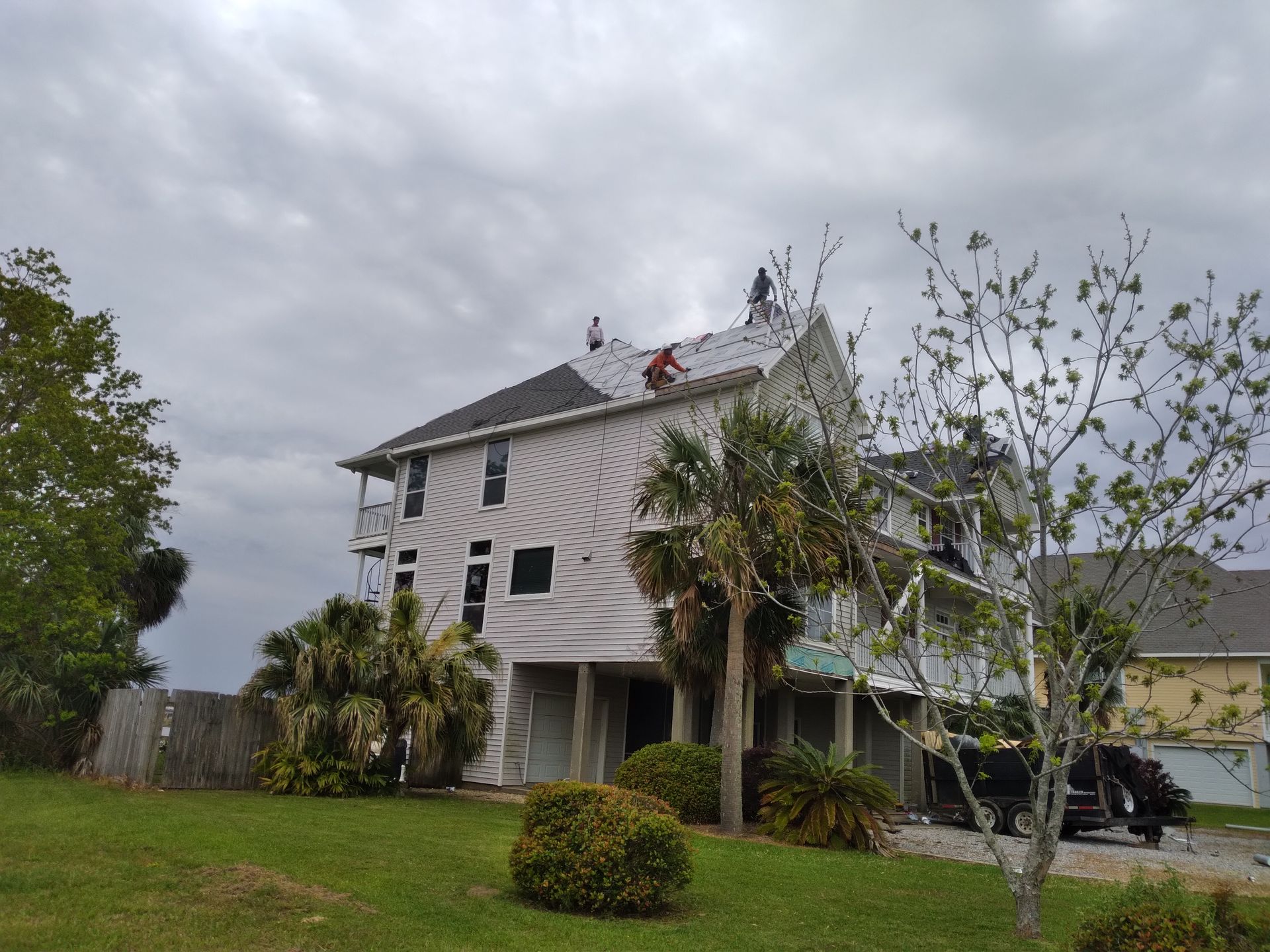 A man is working on the roof of a house