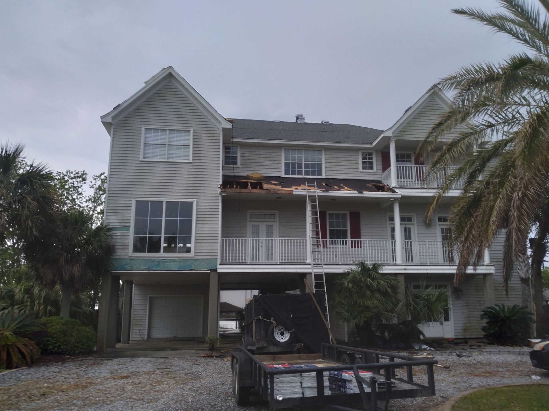 A large house with a trailer parked in front of it