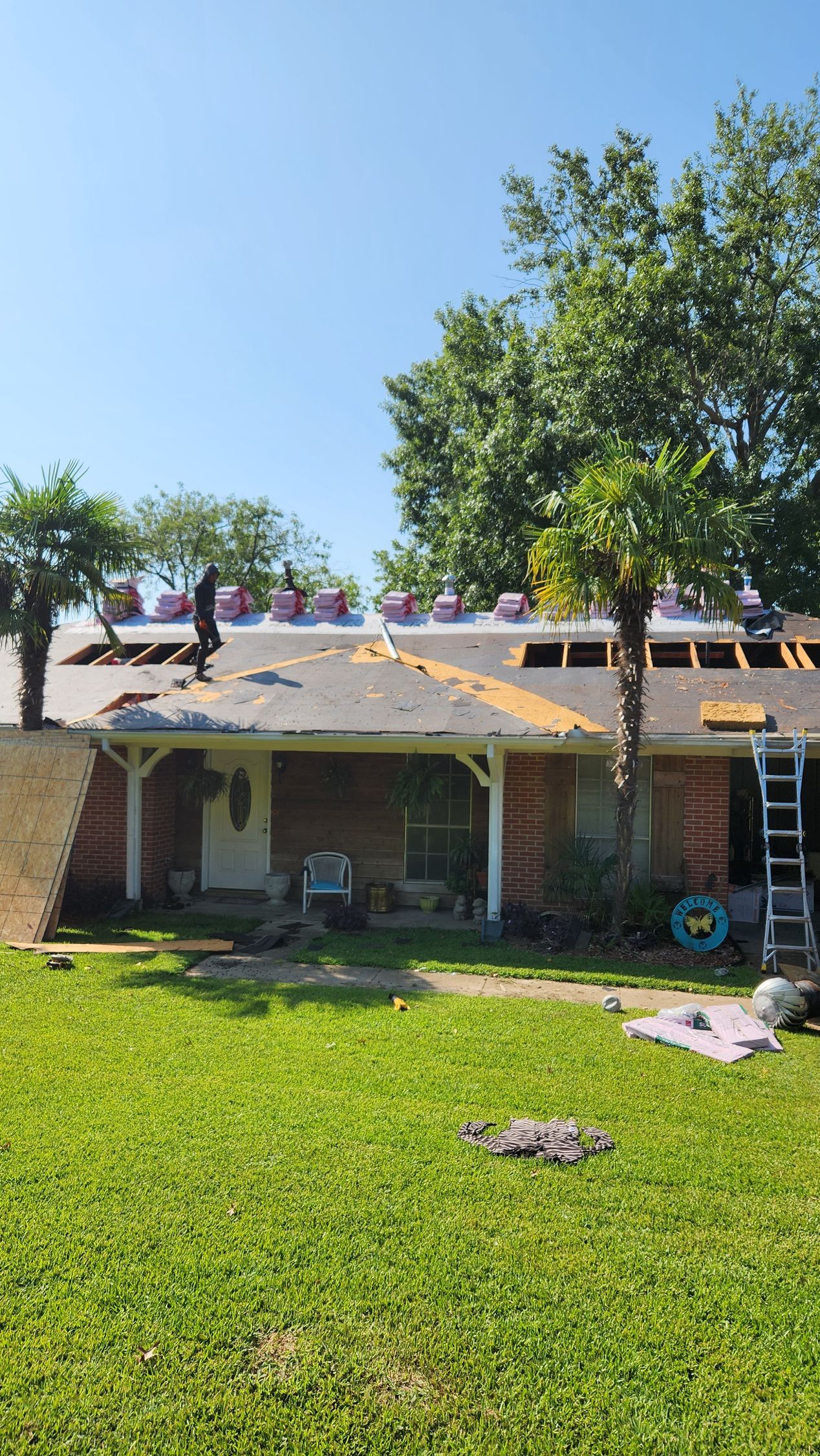 A house is being remodeled with a new roof being installed.