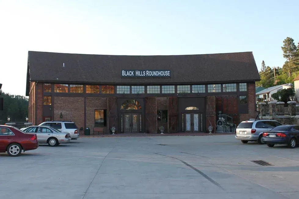 A large brick building with cars parked in front of it