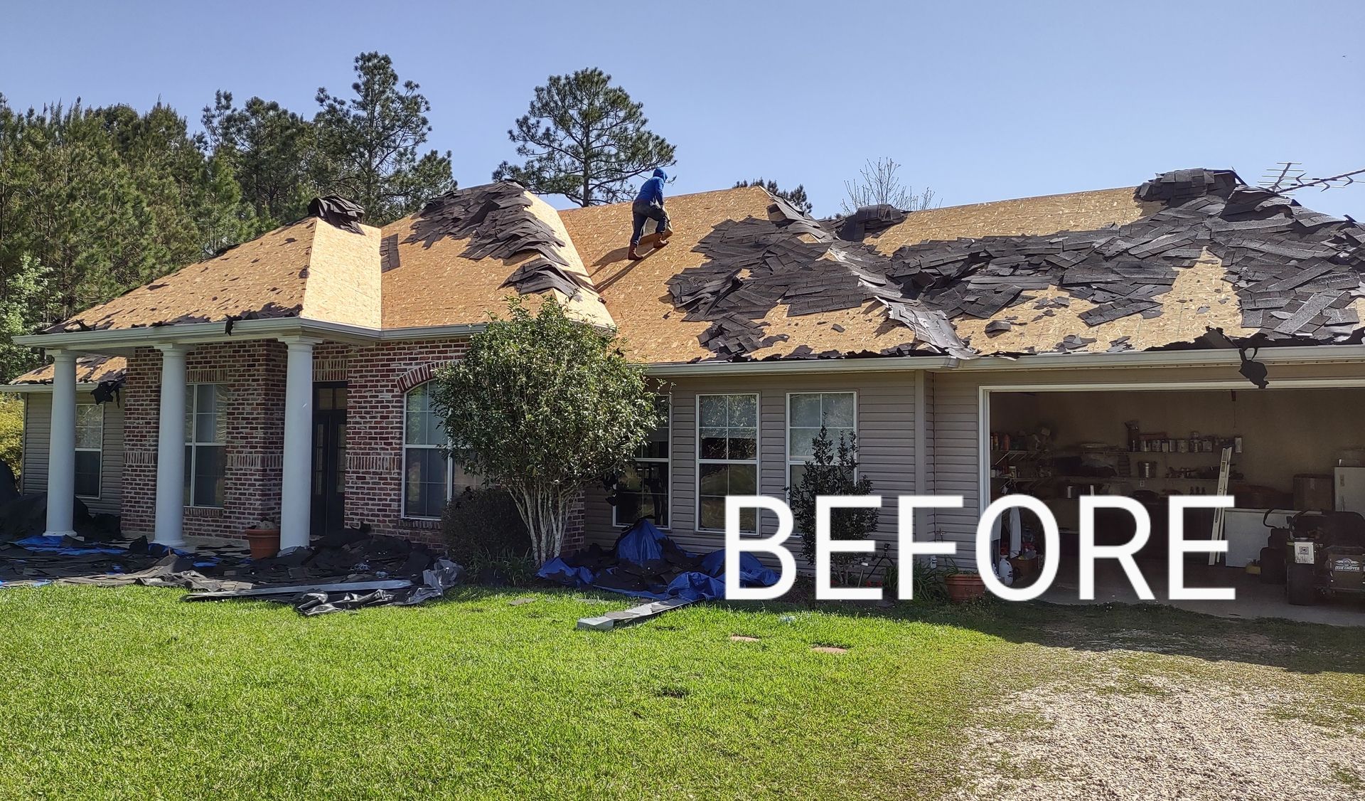 A before picture of a house with a roof being repaired