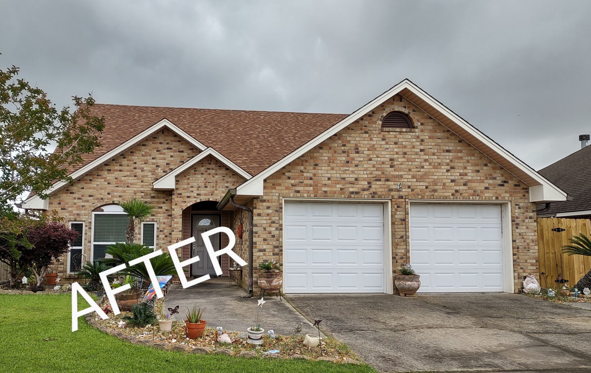 A picture of a brick house with a white garage door and the words `` after '' written on it.
