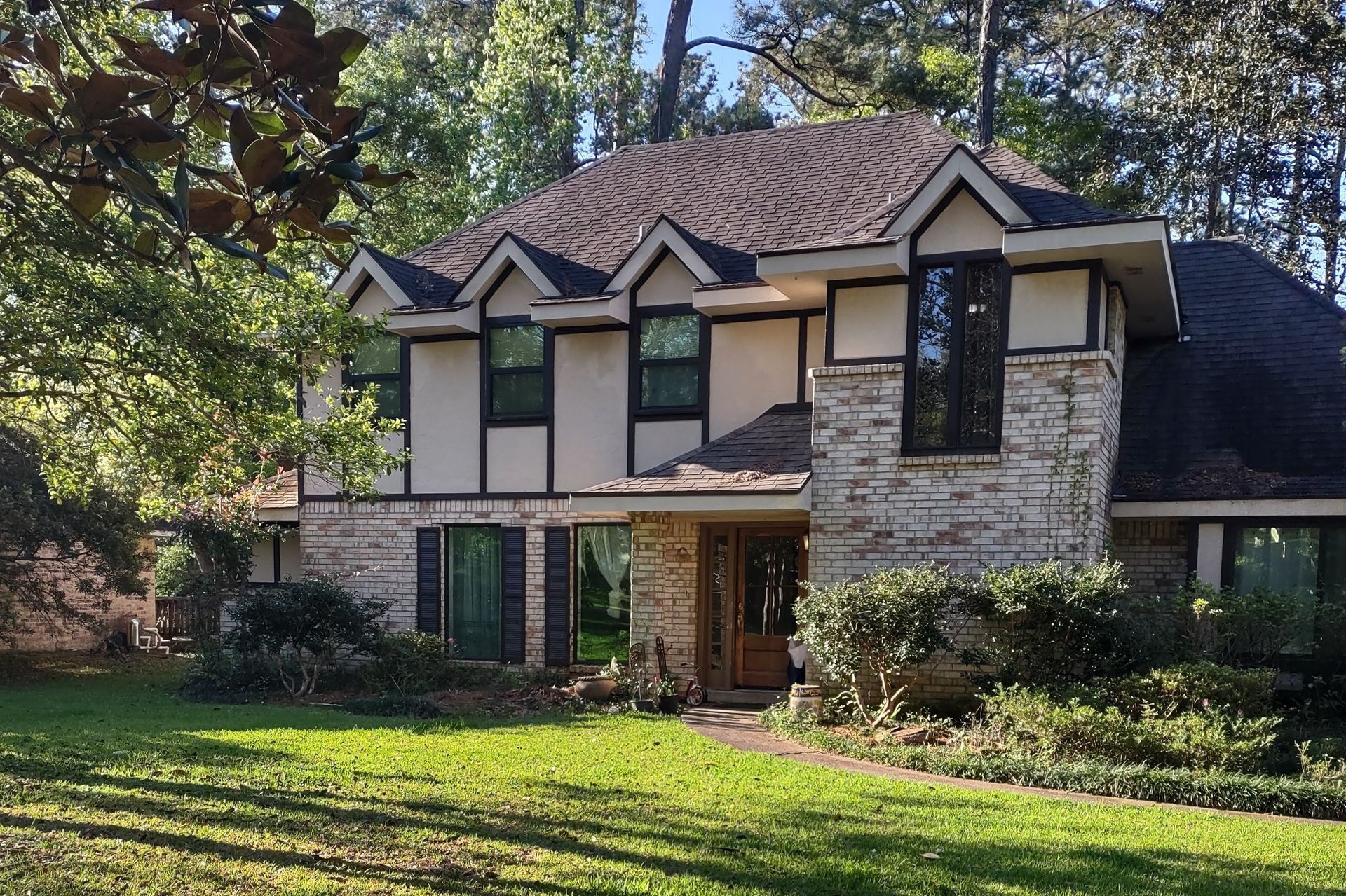 A large house with a lush green lawn in front of it