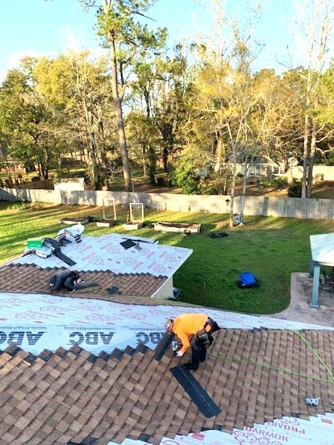 A man is working on the roof of a house