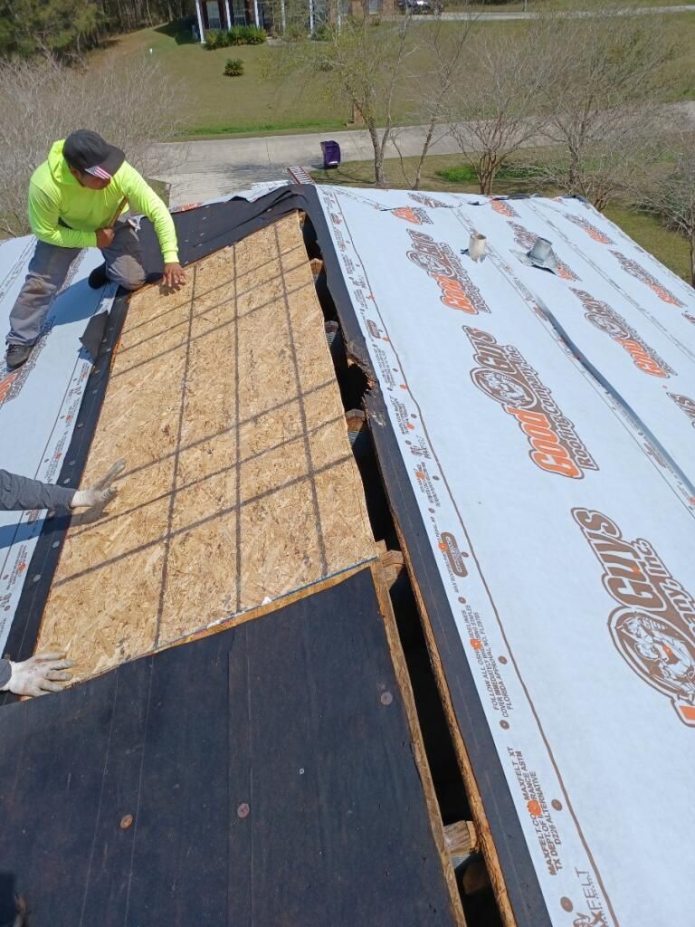 A man is working on the roof of a house