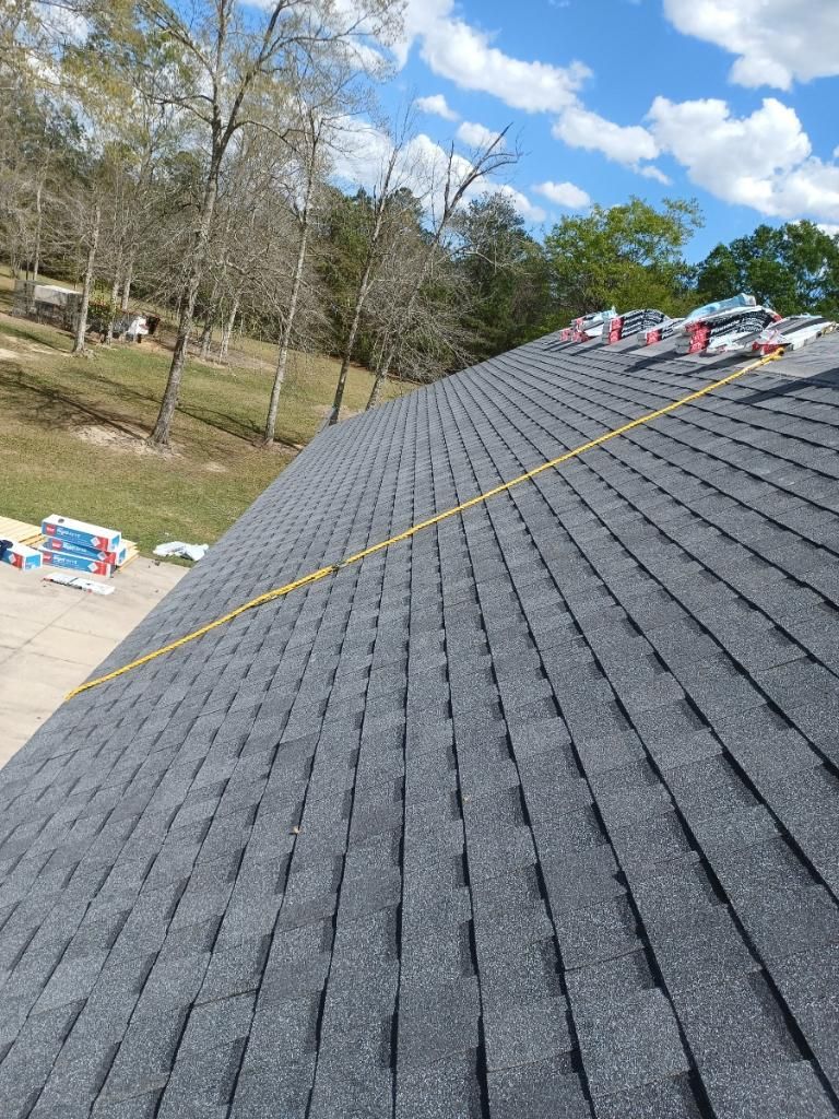 A roof with a lot of shingles on it is being built.
