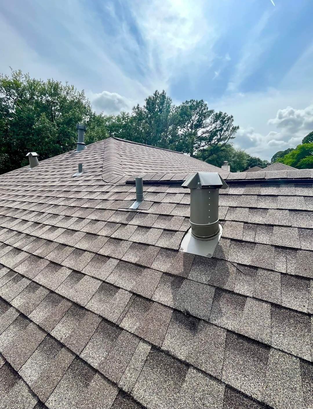 A close up of a roof with a chimney on top of it.