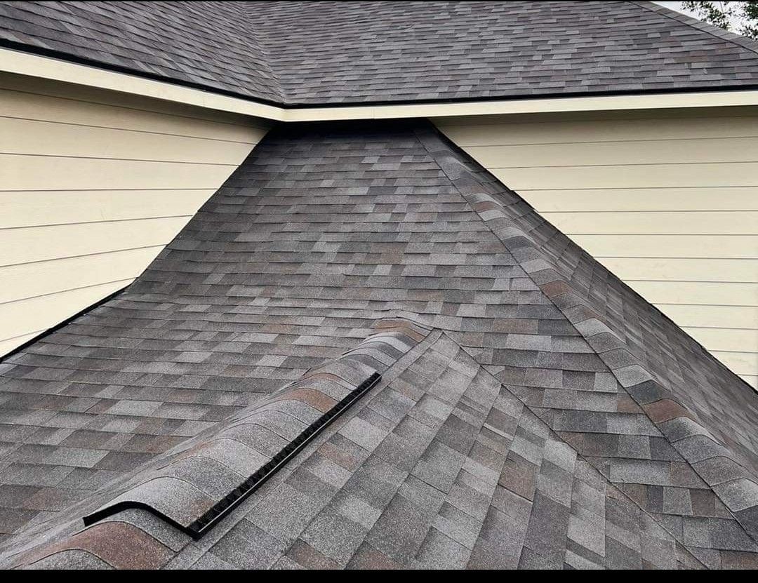 A close up of a roof with shingles on a house.