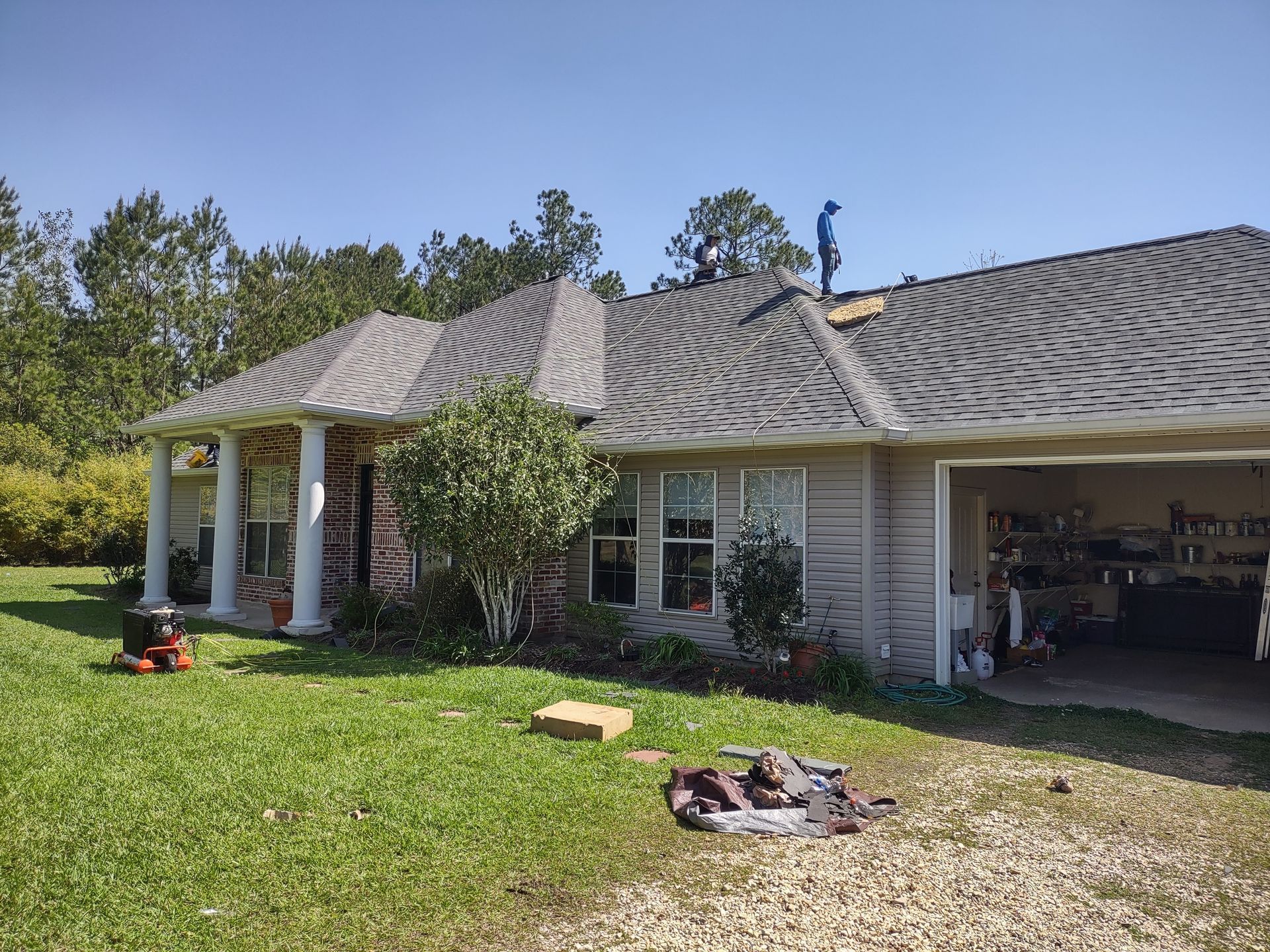 A man is standing on the roof of a house.