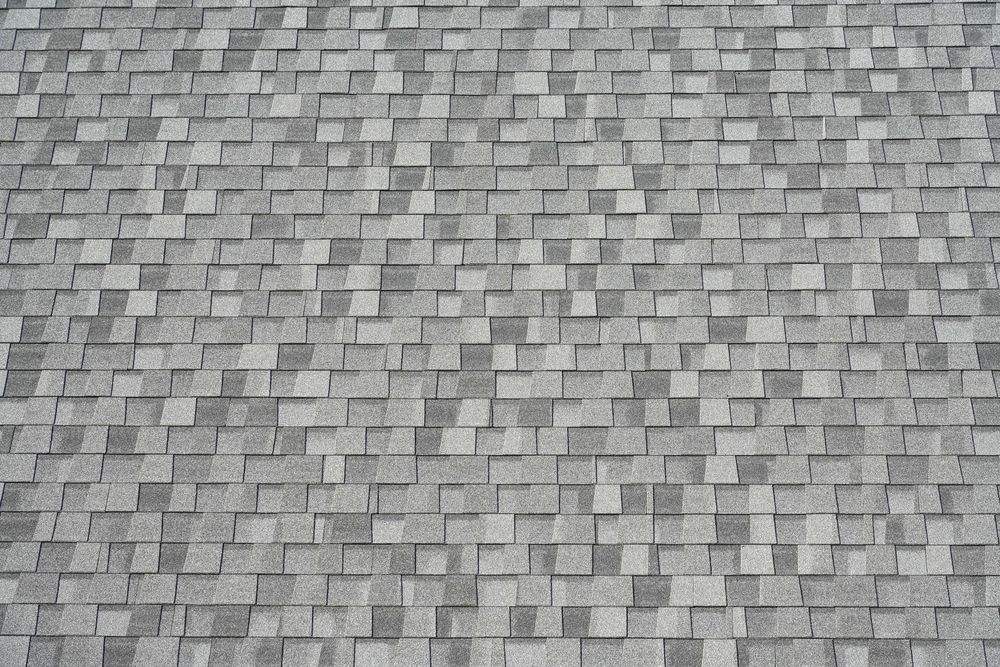 A close up of a roof with a lot of shingles on it.