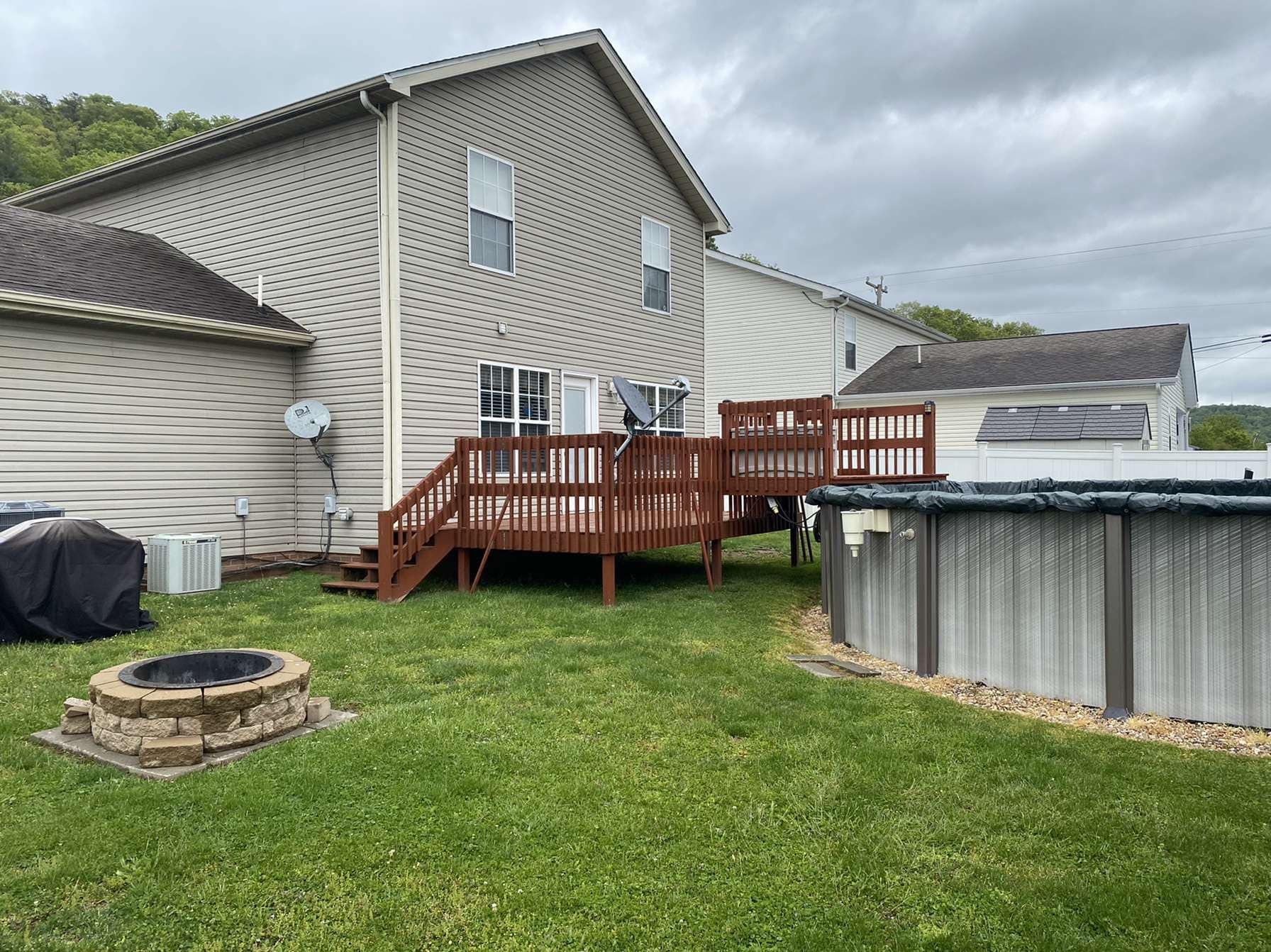 A house with a deck and a pool in the backyard.