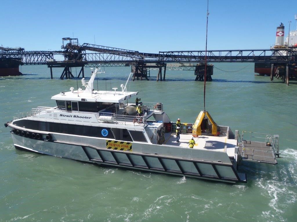 A Person In An Orange Jumpsuit Is Holding A Pen And Pointing At A Piece Of Paper— On-Track Marine In Yorkeys Knob, QLD