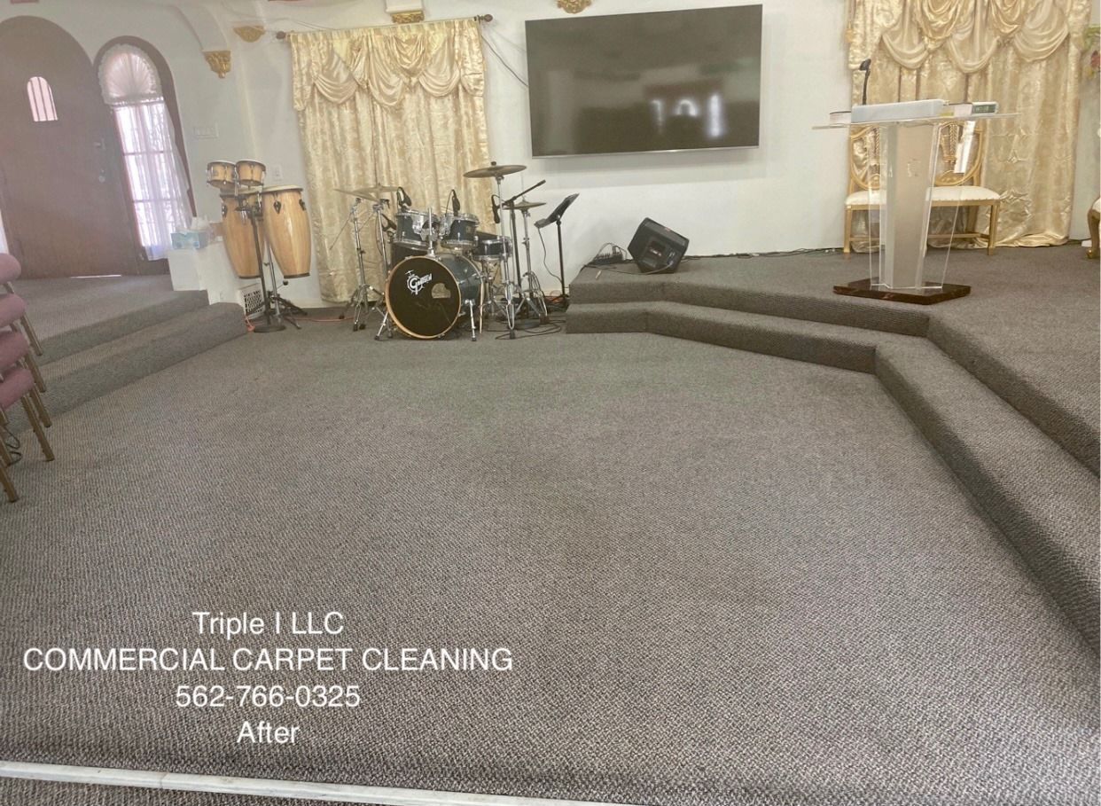 Triple I LLC | a church with a podium and a drum set on the stage.