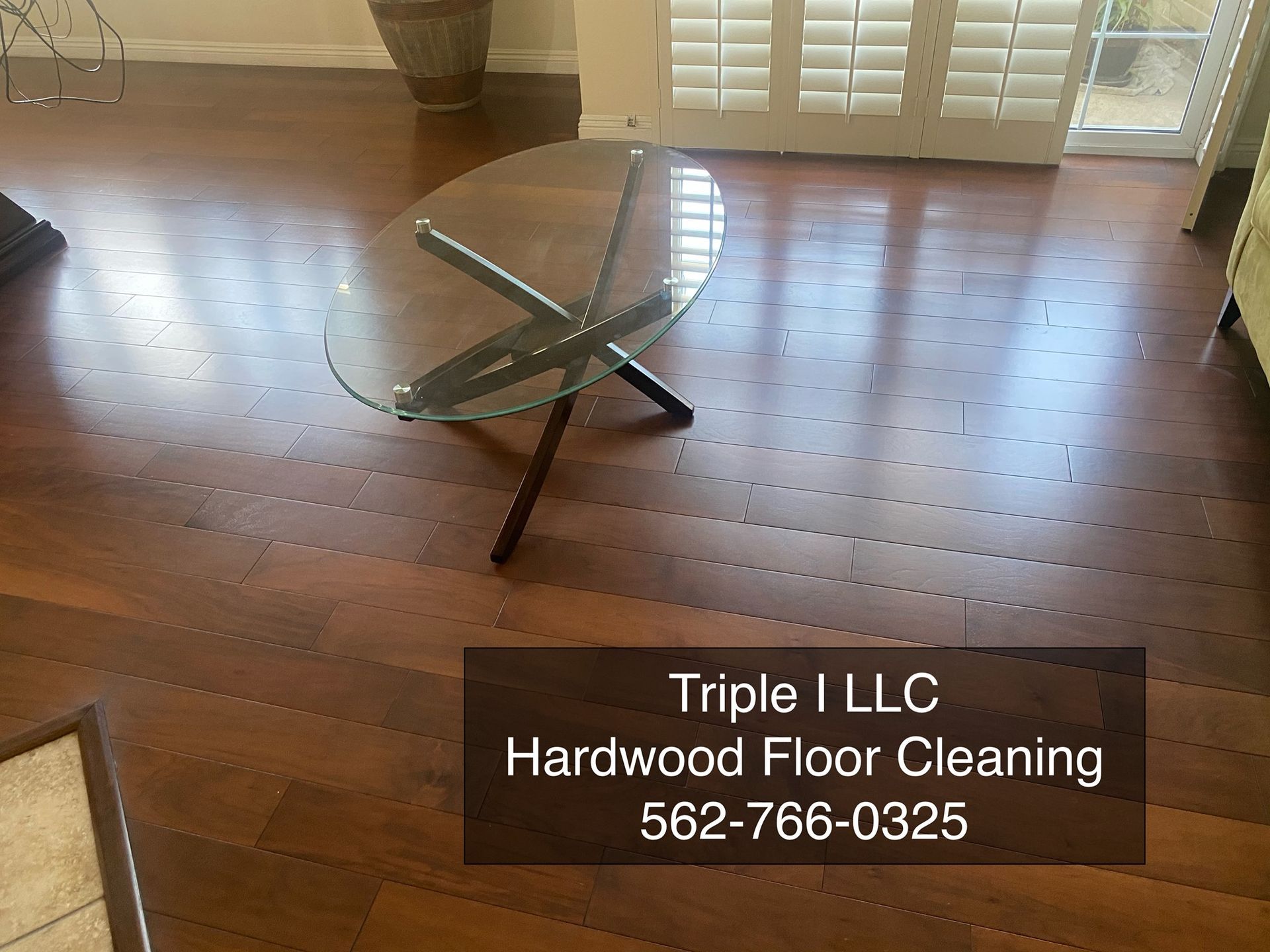 Triple I LLC | a coffee table is sitting on a hardwood floor in a living room.