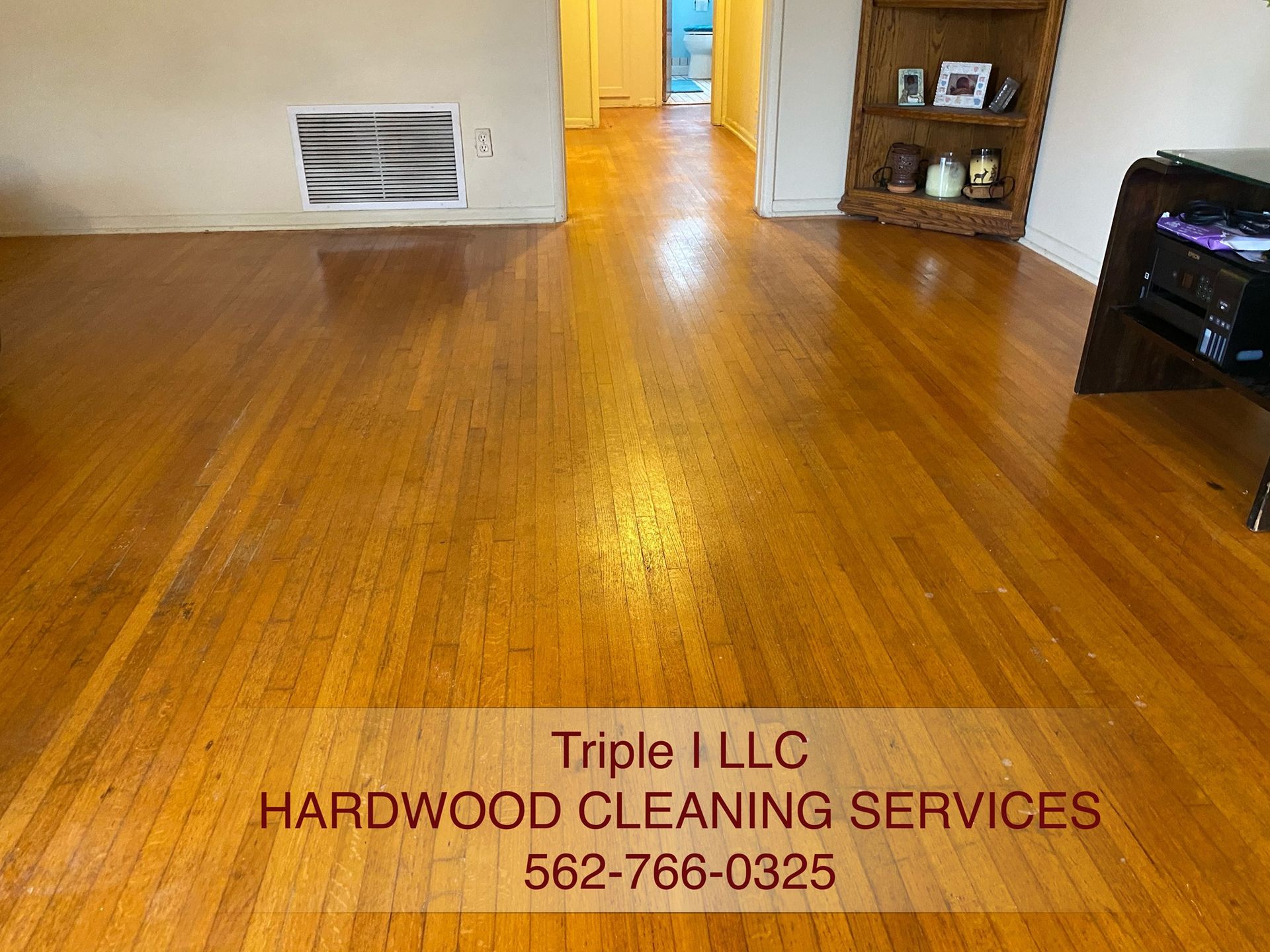 Triple I LLC | a living room with hardwood floors and a bookshelf.