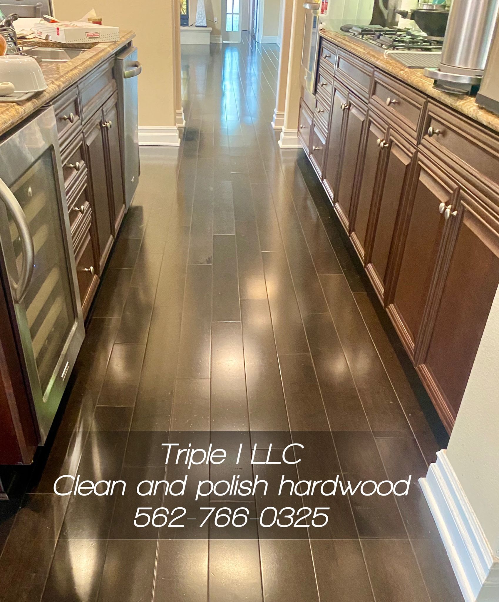 Triple I LLC | a kitchen with hardwood floors and stainless steel appliances