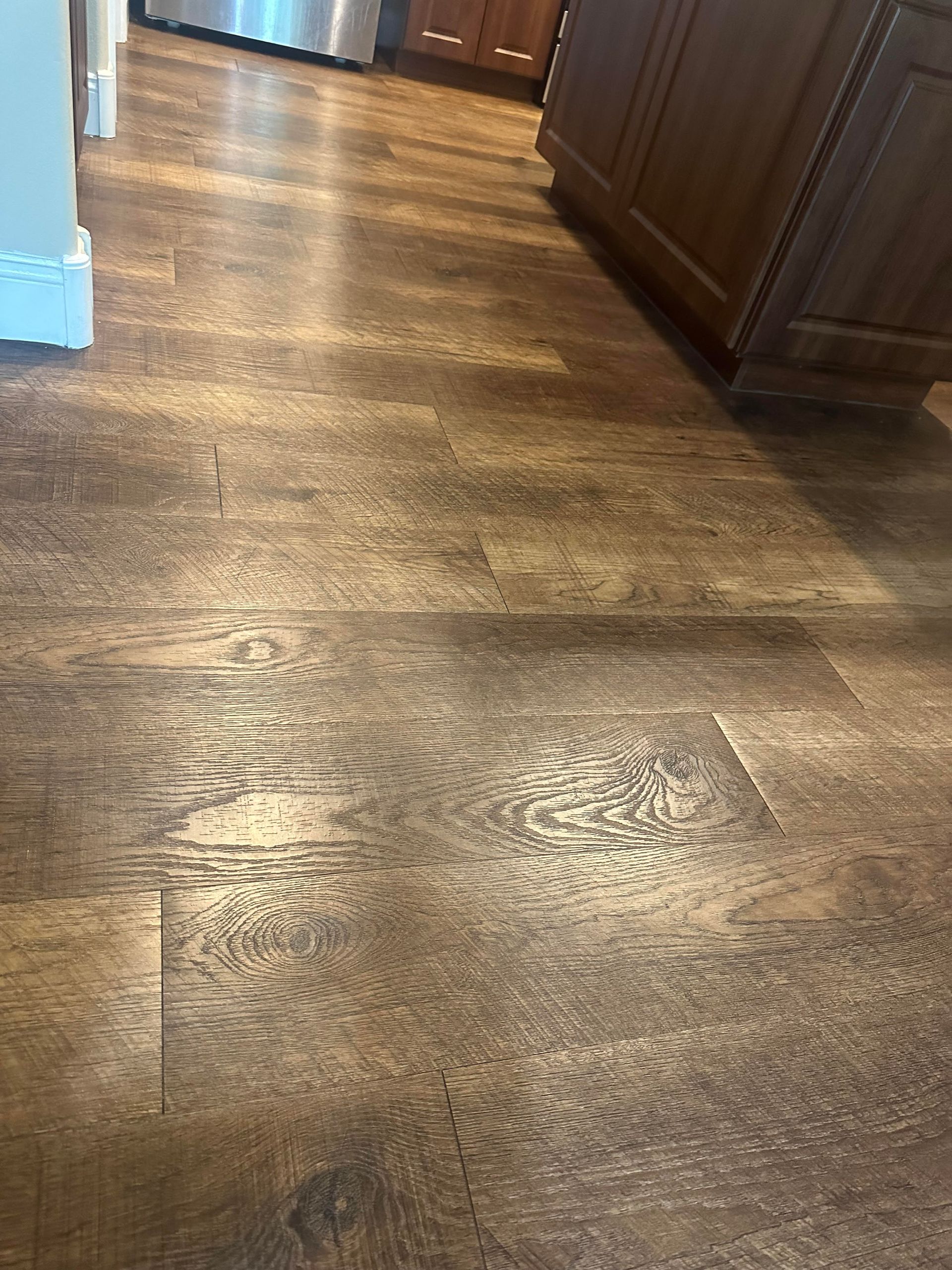 Triple I LLC | A hallway with a wooden floor and a railing