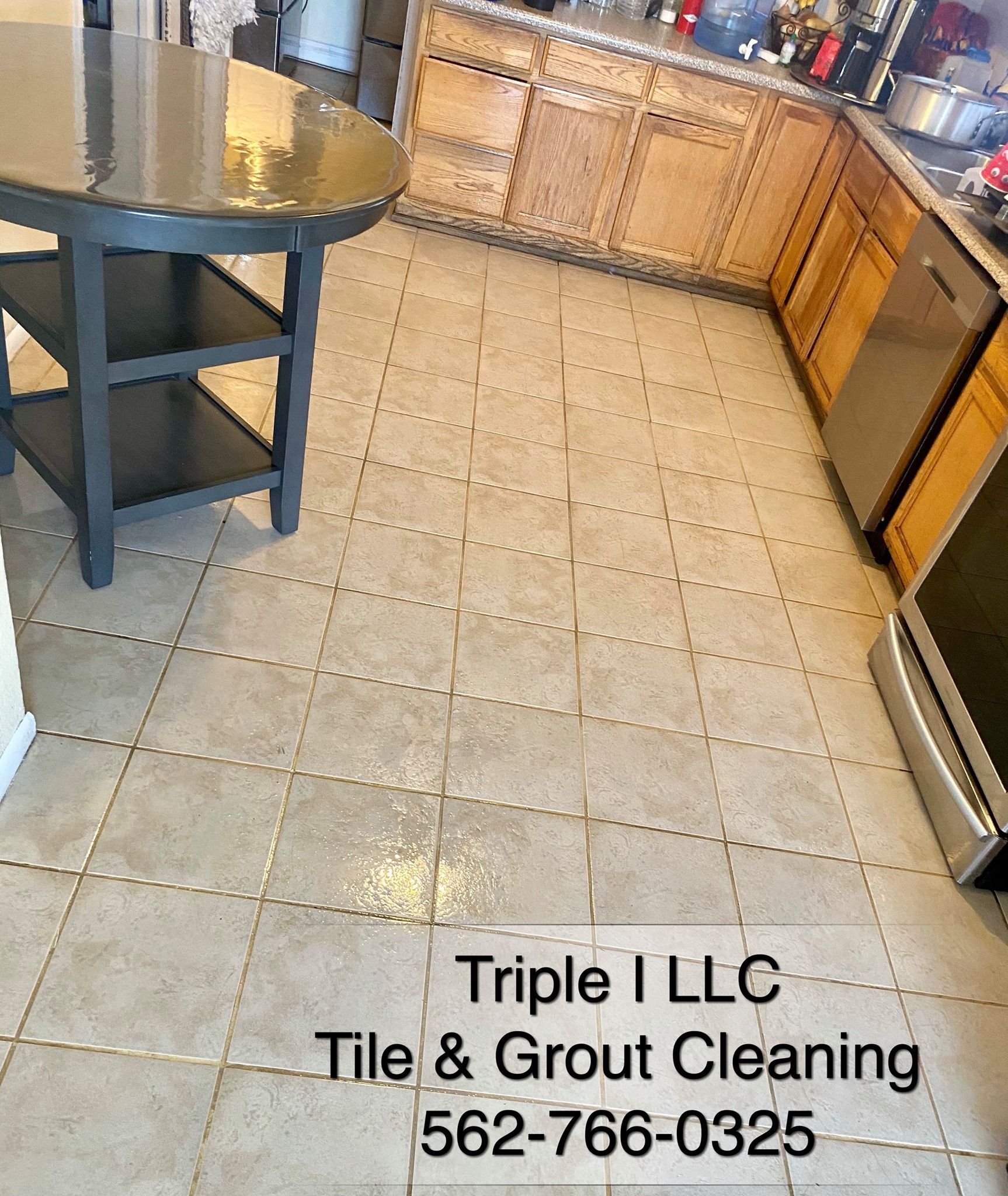 Triple I LLC | a kitchen with tile floors and stainless steel appliances